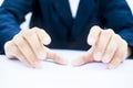 Close up of two hands of a business man wearing blue suit on white trying to save something imagery.