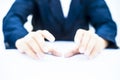 Close up of two hands of a business man wearing blue suit isolated on white trying to save something imagery.