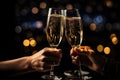 Close up of two hands clinking glasses of champagne with bokeh background, Hands of couple with flutes of champagne and their Royalty Free Stock Photo