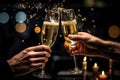 Close-up of two hands clinking glasses of champagne with bokeh background, Hands of couple with flutes of champagne and their Royalty Free Stock Photo