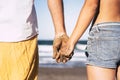 Close up of two hands holding between together at the beach with the hands dirty of sand - vacations outdoors in relationship Royalty Free Stock Photo