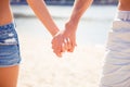 Close up of two happy young lovers holding hands Royalty Free Stock Photo