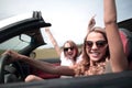 Close up. two happy young women traveling in a car Royalty Free Stock Photo