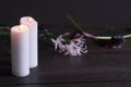 Close-up of two large white candles burning on a dark background, selective focus Royalty Free Stock Photo