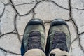 Top view hiking boots on dry muddy soil surface for background texture Royalty Free Stock Photo