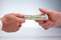 Close-up Of Two Male Hand`s Holding Currency Bundle Royalty Free Stock Photo