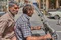 Close-up of two mature men on a motorcycle, Kashan, Iran.