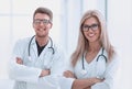 Two medical doctors with stethoscopes standing in the hospital corridor