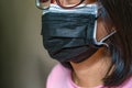 Close Up Two Medical Masks On An Asian Woman`s Face, The Concept For More Protection Covid 19 Delta Variant Virus
