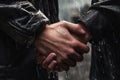 Close-up of Two men holding hands in the rain