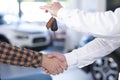 Close-up of two men shaking hands after making a deal. Seller ho Royalty Free Stock Photo