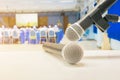 Close up two microphone wireless Stand on white table in business conference interior seminar meeting room Royalty Free Stock Photo