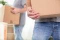 close-up two mover hand in uniform carrying cardboard box Royalty Free Stock Photo