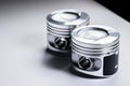 Close-up of two new internal combustion engine piston on a gray gradient background. The concept of new spare parts of Royalty Free Stock Photo