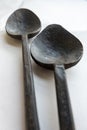 Close-up of two old iron spoons on white background