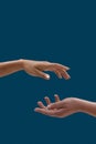Close up of two open cupped female hands with empty space between them isolated over blue background