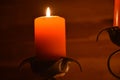 Close up of two orange colored Candles
