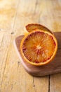 Close-up of two orange halves, on table, on rustic table, in vertical Royalty Free Stock Photo