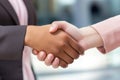 A Close Up Of Two People Shaking Hands