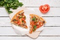 Close-up, two pieces of hot pizza with cheese on a white wooden background Royalty Free Stock Photo