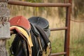 Close up of two saddles on the fence Royalty Free Stock Photo