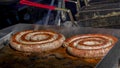 Close up from two sausages cooking on grill Royalty Free Stock Photo