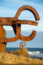 Close-up of two sculptures of the comb of the Wind, at dawn with blue sky, in vertical, in San Sebastian, Basque Country