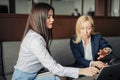 Close up of two serious employees co-working on line with a laptop at office Royalty Free Stock Photo