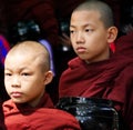Close up of two serious young Buddhist novices in maroon robes,Myanmar