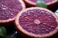 a close up of two slices of blood orange with water droplets