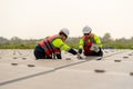 Close up of two technician workers sit and work on process of maintenance solar cell panel network system in concept of green Royalty Free Stock Photo