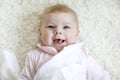 Close-up of a two or three months old baby girl with blue eyes. Newborn child, little adorable peaceful and attentive Royalty Free Stock Photo