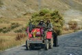 CLOSE UP Two unrecognizable farmers in Tibet transporting their crops by tractor