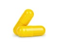 Close-up two yellow medical capsules on white