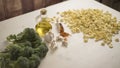 Close-up of typical Italian Apulian fresh pasta orecchiette on a table with broccoli, garlic, oil and chilli powder Royalty Free Stock Photo