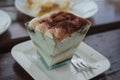 Close up of typical Italian sweet pastry - Tiramisu with mascarpone in transparent cup