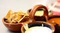Close-up typical Mexican snack, clay pot with cream chips and salsa Royalty Free Stock Photo