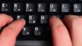 Close Up Typing on a Black Keyboard with Hiragana Keys