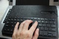 Close-up of typing on laptop keyboard of young man hands. Business trading copywriting concept