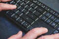 Close-up of typing man`s hands on black keyboard. hand writing something on the computer keyboard