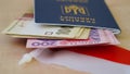 Close-up of a Ukrainian biometric passport with hryvnia banknotes on the background of the Polish flag.The concept of currency Royalty Free Stock Photo