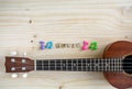 Close up of ukulele on old wooden background