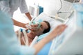 Doctor putting oxygen mask on patient in critical state