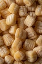 Close-up of uncooked gnocchi pasta on a wooden surface