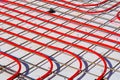Underfloor heating system with red pipes on construction site Royalty Free Stock Photo