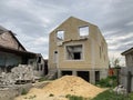 Close up of unfinished house in residential area. Modern architecture of construction brick house for comfortable stay