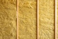 Close up of unfinished wall with mineral wool isolation between wooden beams