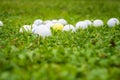 Close-up of unfocused grass and a group of golf balls on grass, horizontal, Royalty Free Stock Photo