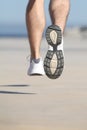 Close up of an unfocused man legs running on the concrete of a seafront