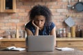Close up unhappy African American woman using laptop, standing Royalty Free Stock Photo